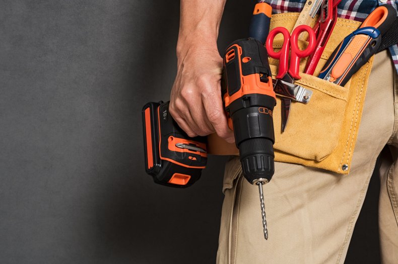 Man with tool belt holding drill