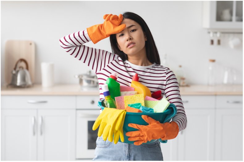 Stock image of overworked person cleaning 