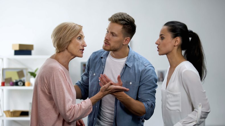 man stands in between wife and mother