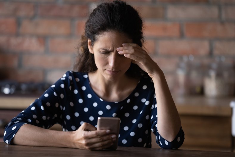 Woman looks upset confused at phone