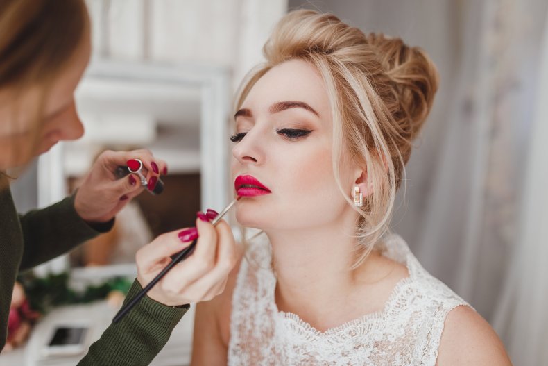 A bride getting her makeup done.