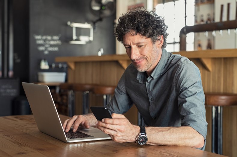 Man sitting in café at laptop