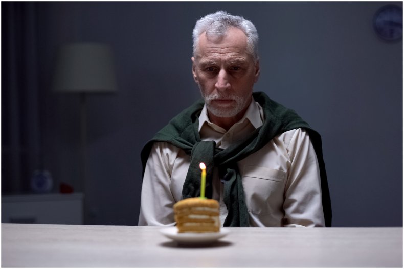 Stock image of sad man with cake