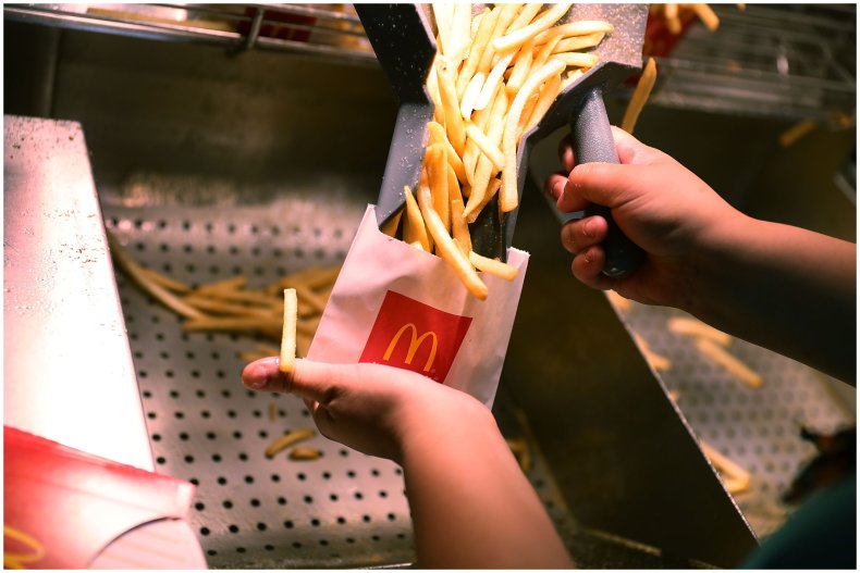 Photo of McDonald's employee filling fries bag