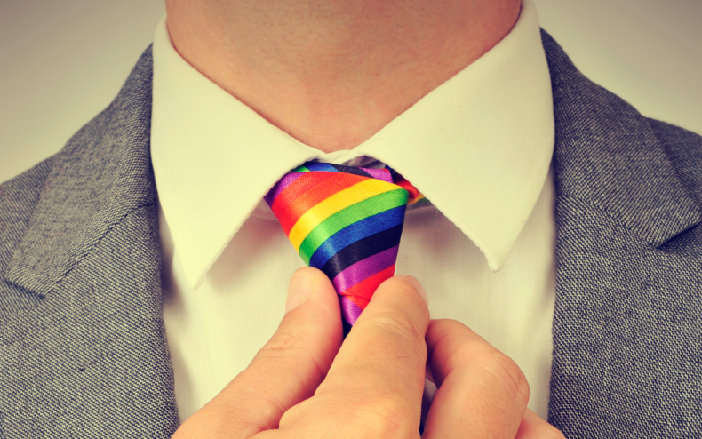 A fit man with a rainbow tie.