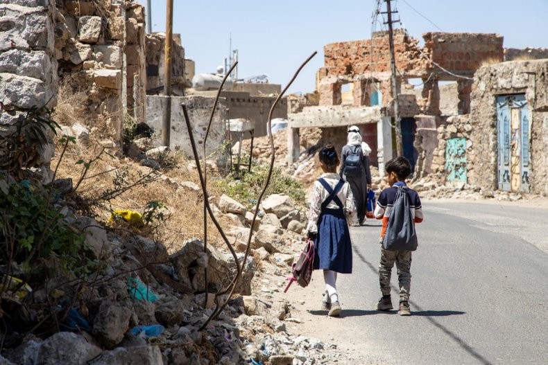 Two students walk towards their school