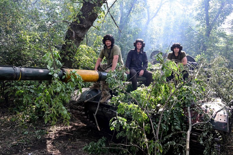 Ukraine soldiers sit on tank near frontline