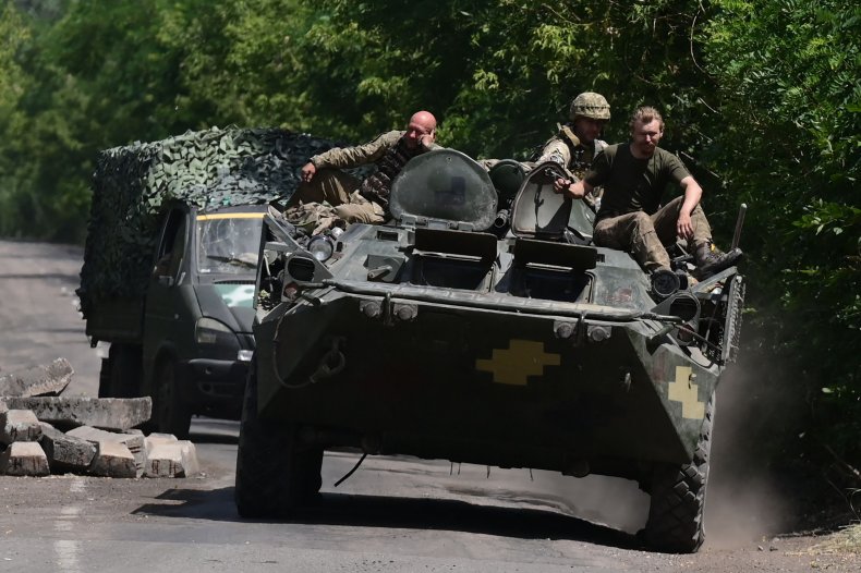 Ukraine troops ride on APC in east