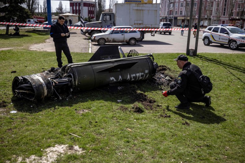 Ukrainian police inspect a large rocket 