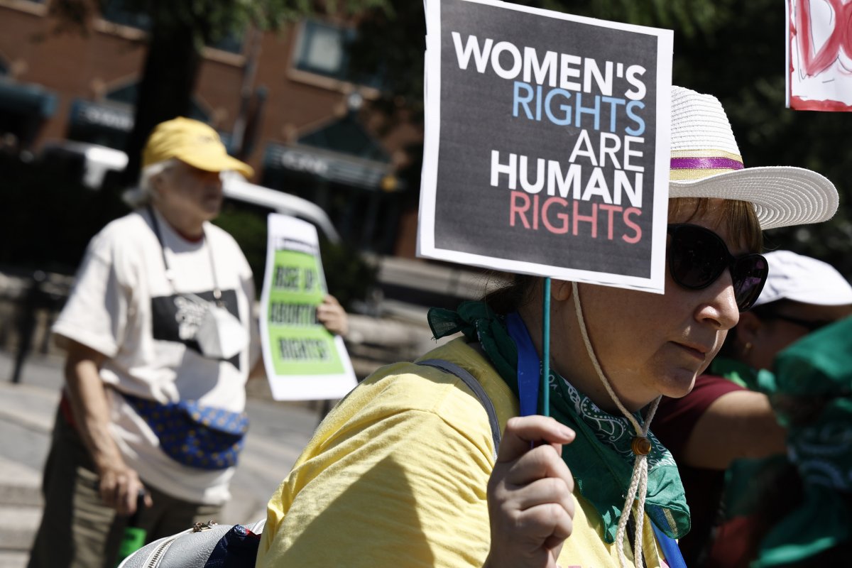 A Woman Holds A Women's Rights Sign