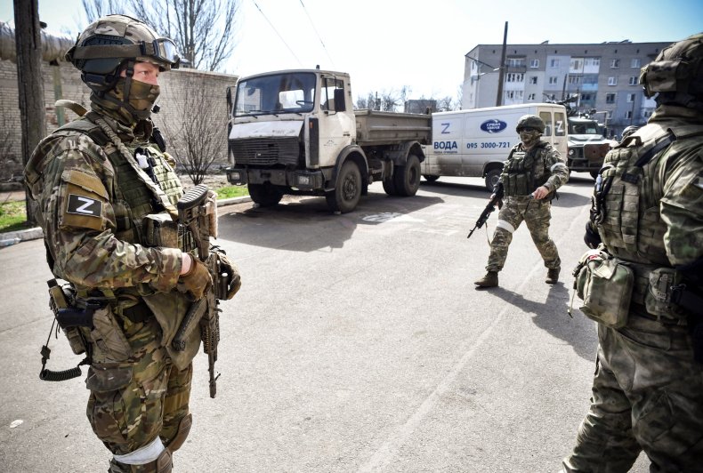Russian soldiers patrol a street in Donetsk