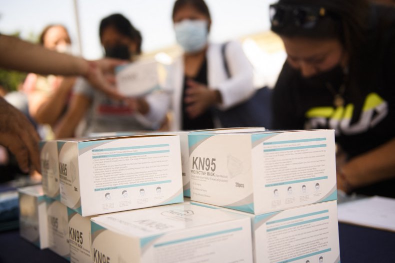 People receive boxes of KN95 face masks
