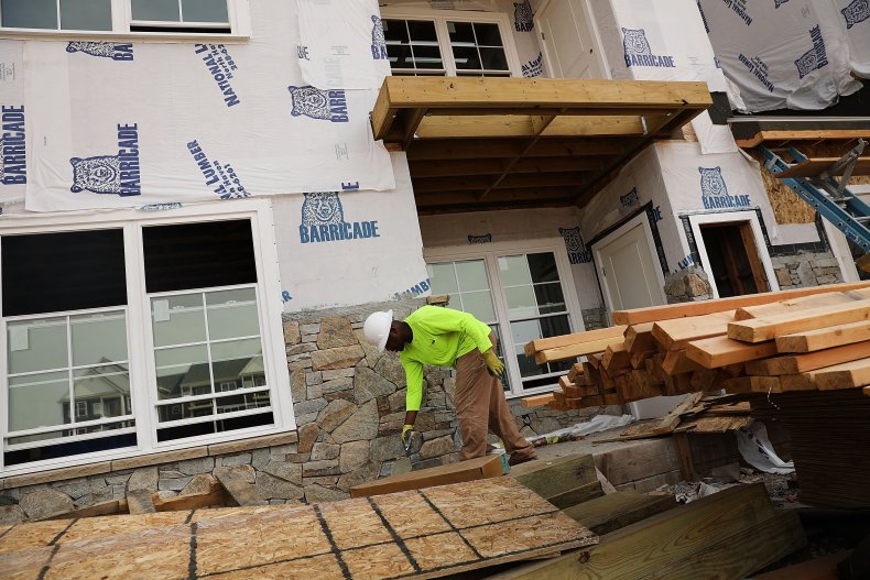 A mason works on a new housing complex
