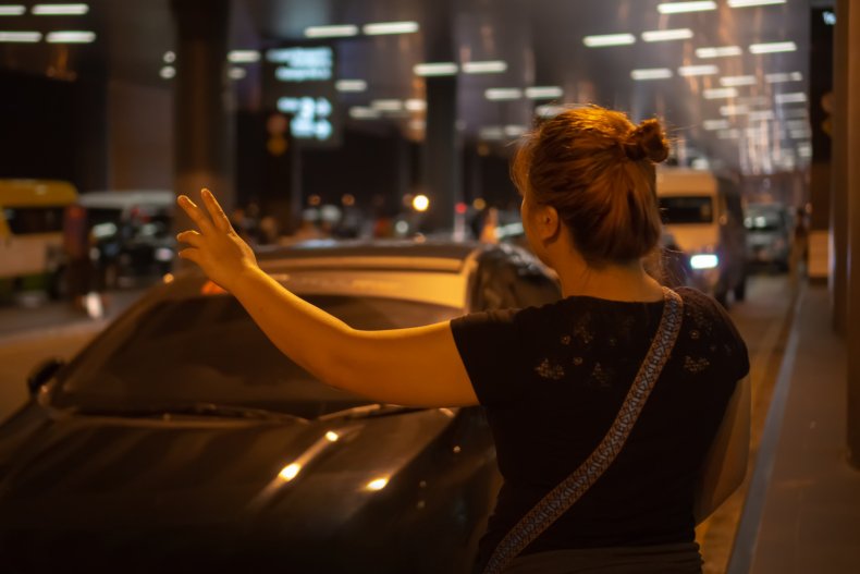 Woman hails cab at night