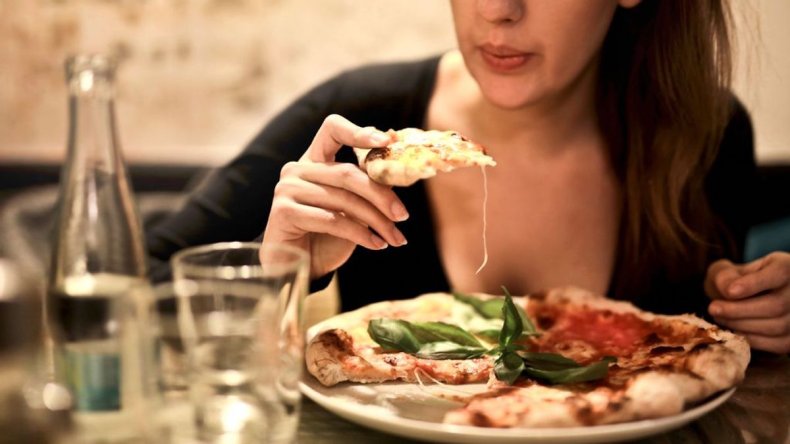 Woman eating pizza