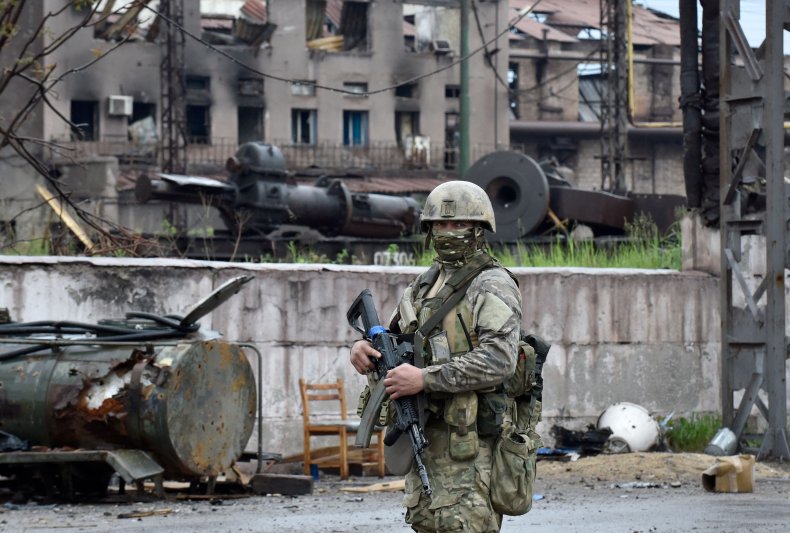 A Russian serviceman stands guard in Mariupol