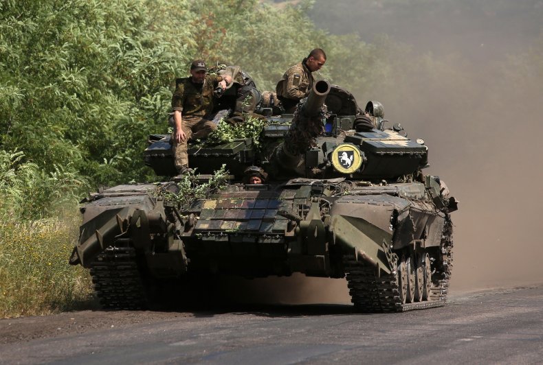 Ukrainian soldiers ride a tank