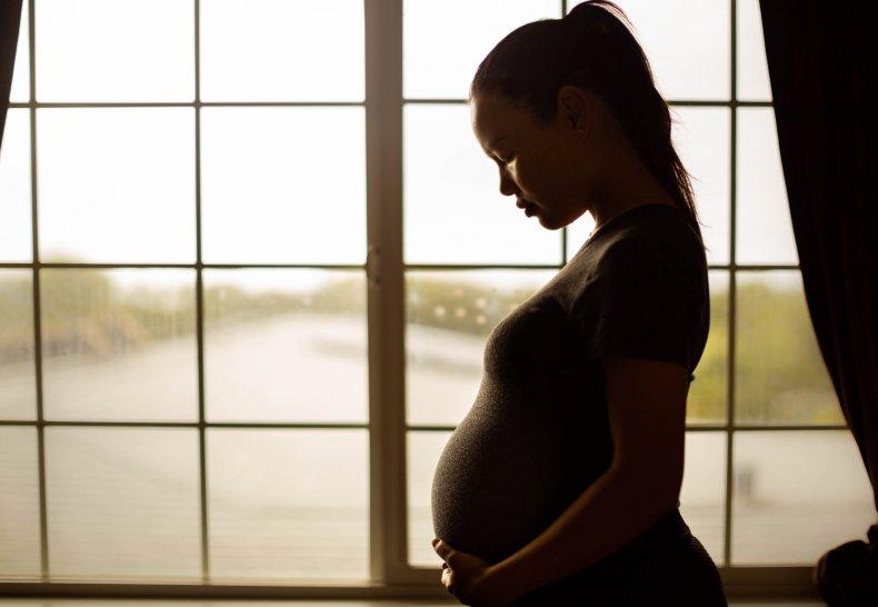 Pregnant Woman Holding Stomach