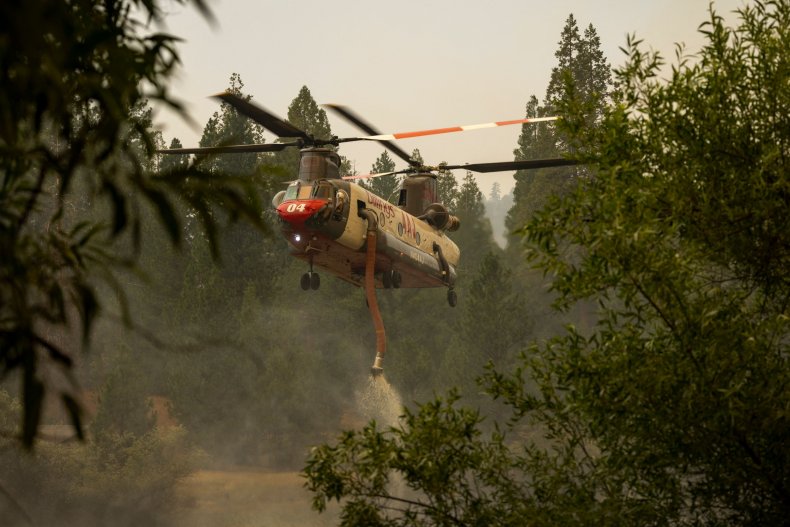 A Billings 4AJ helicopter refills with water