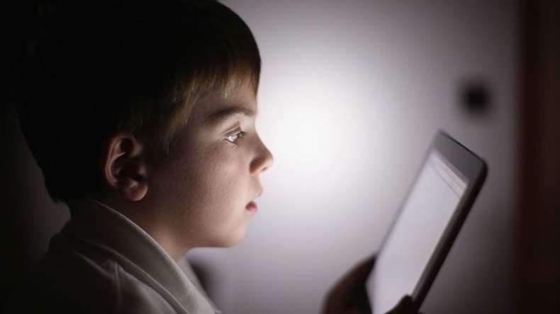 Boy plays on iPad