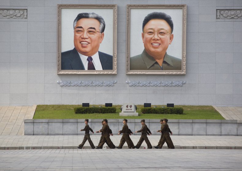 Portraits of Kim Jong-Il and Kim Il-Sung.