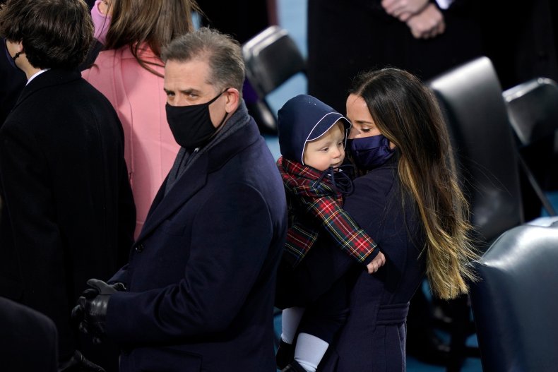 Ashley Biden carries her nephew alongside half