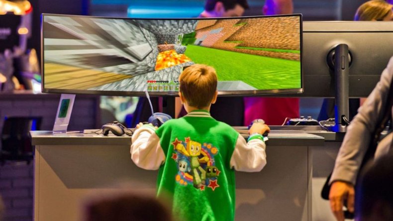 Boy plays video game on ultrawide TV