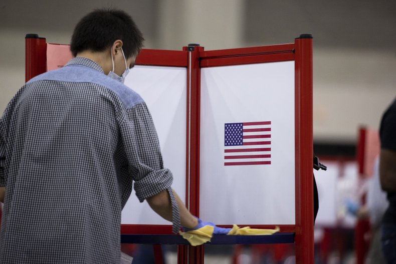  A polling worker cleans a voting booth