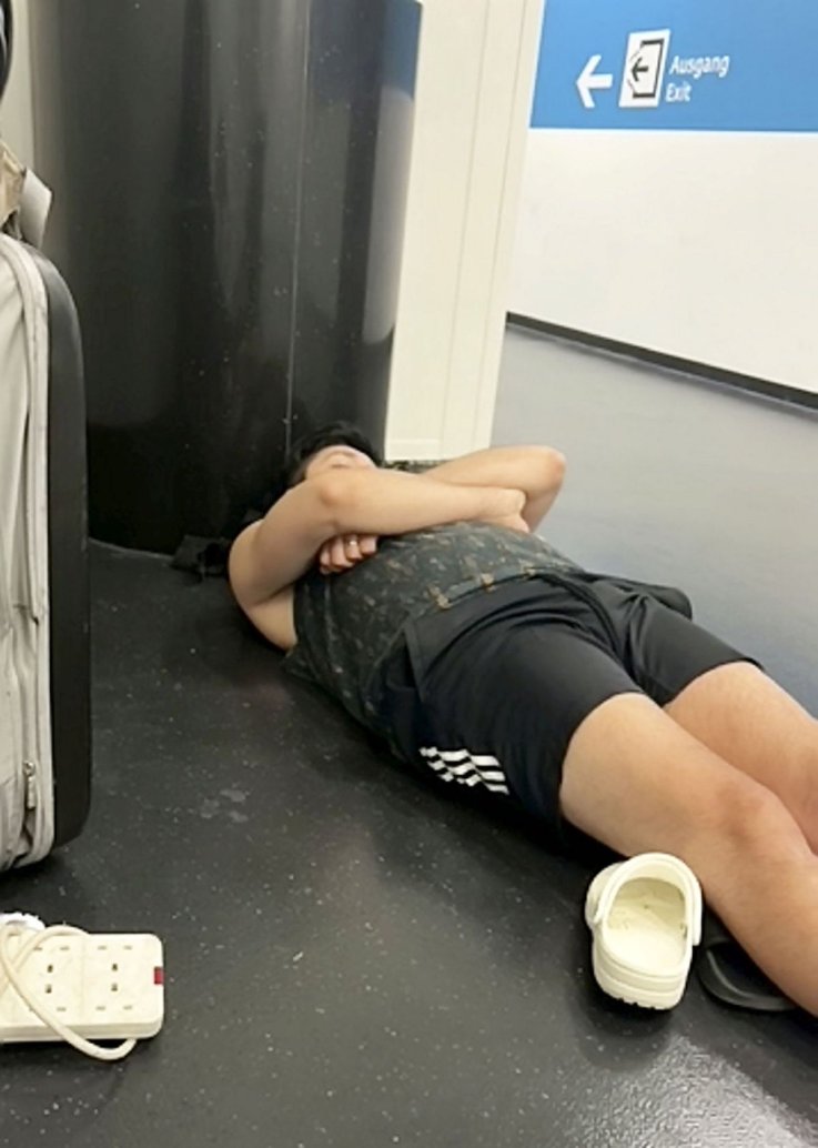 Justin Elliott sleeps on the airport floor