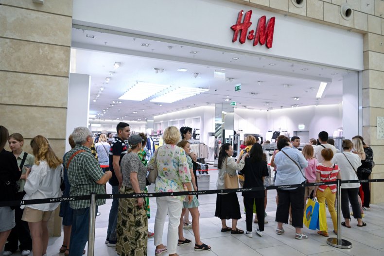 People queue outside an H&M clothing store