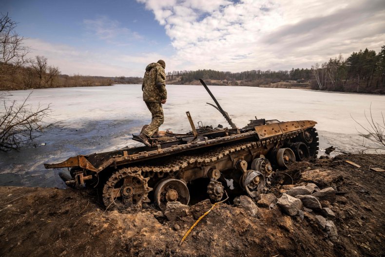 A Ukrainian serviceman near a tank