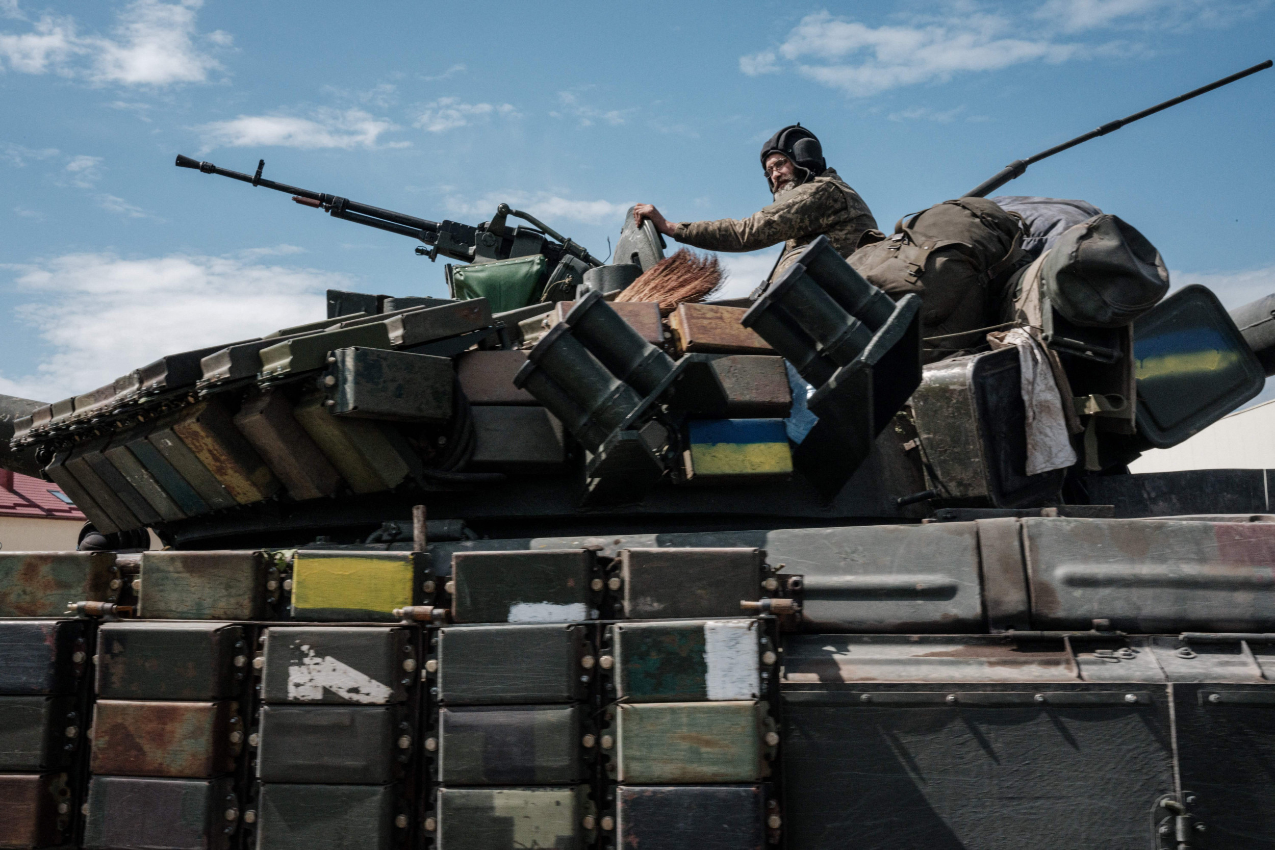 A Ukrainian soldier sits on a tank 