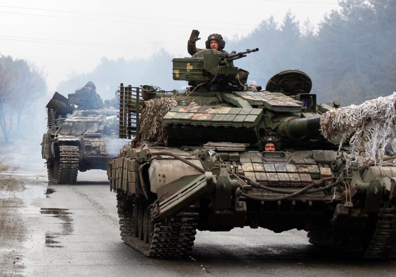 Ukrainian servicemen ride on tanks 