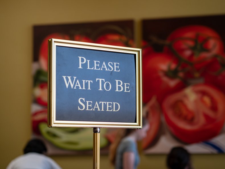 Sign saying "Please wait to be seated"