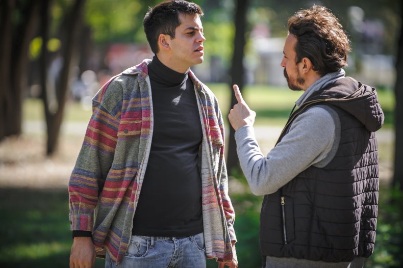 Brothers-in-law arguing over parenting book