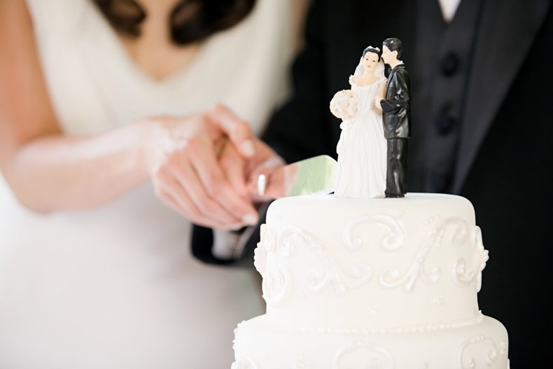 Newlyweds slicing cake