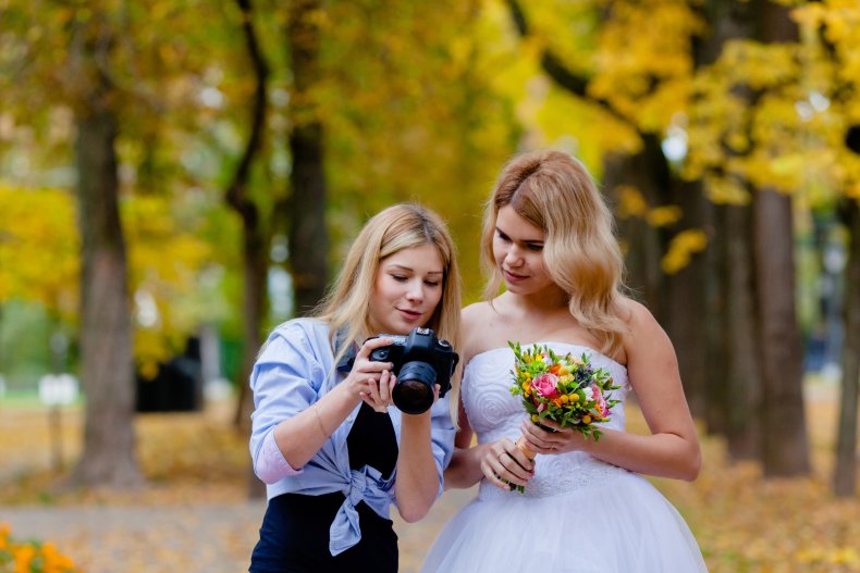 Wedding photographer showing bride photos