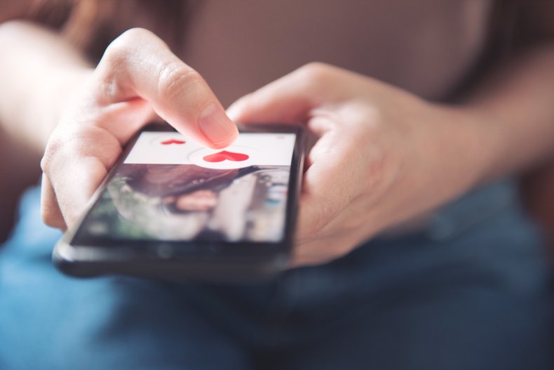 A person's hands using a mobile phone.