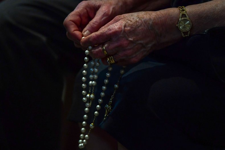 Rosary Held by Faithful