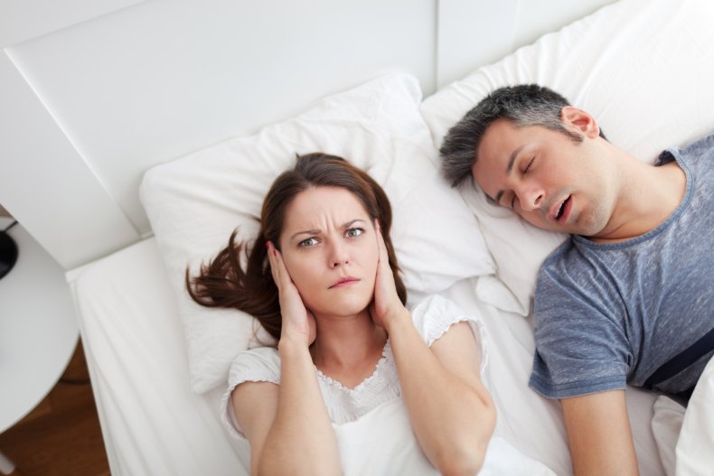Woman struggles with man's snoring