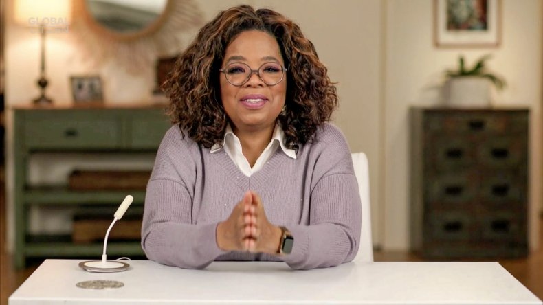 Oprah Winfrey sitting at desk smiling