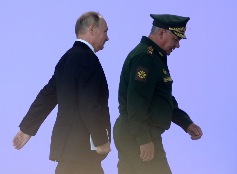 Vladimir Putin walks with Defense Minister