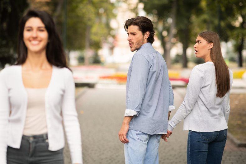 Man looking at woman while with partner.