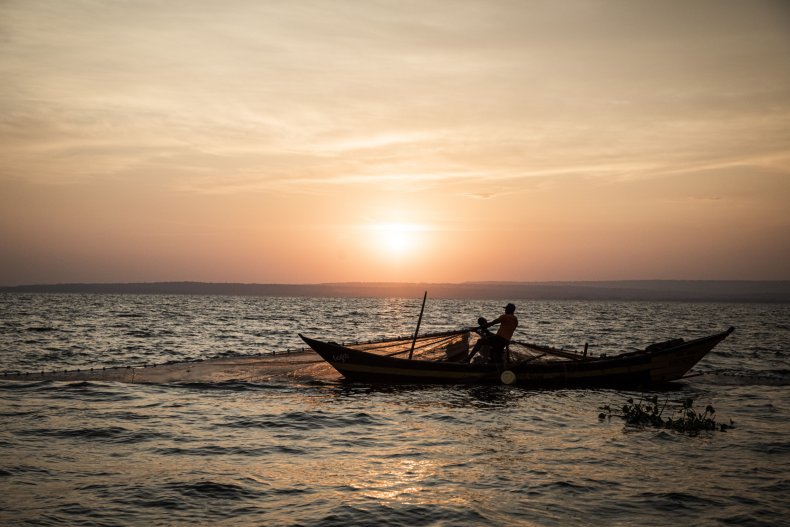 Men fish using a large net