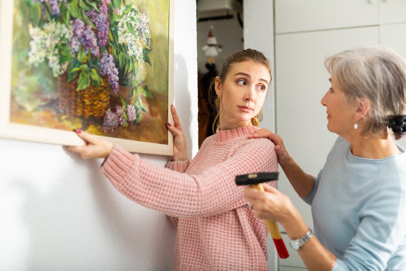 Mom and mother-in-law hanging a painting