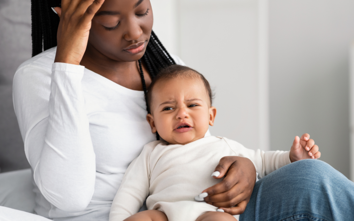 Woman looking fed up with baby.