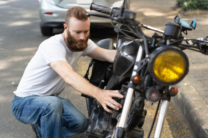 Man examining motorcycle