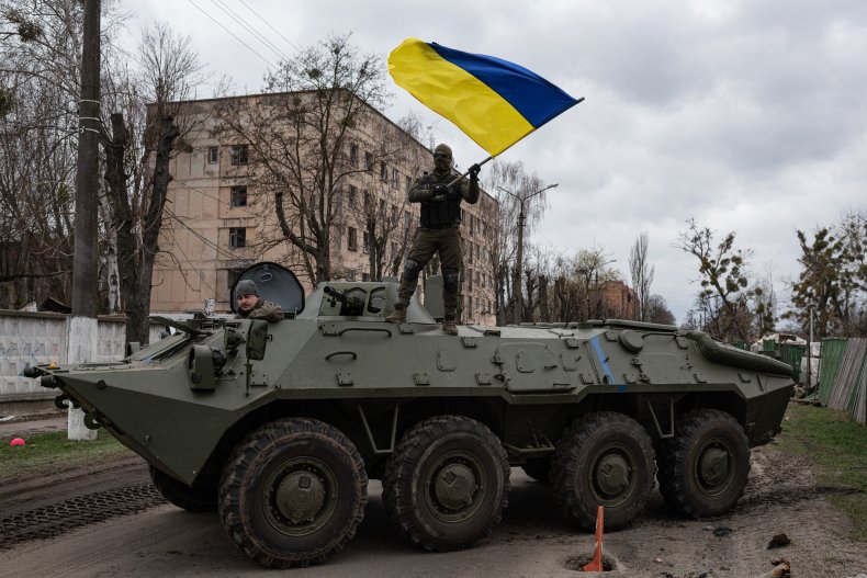 Ukrainian soldier waves Ukrainian national flag