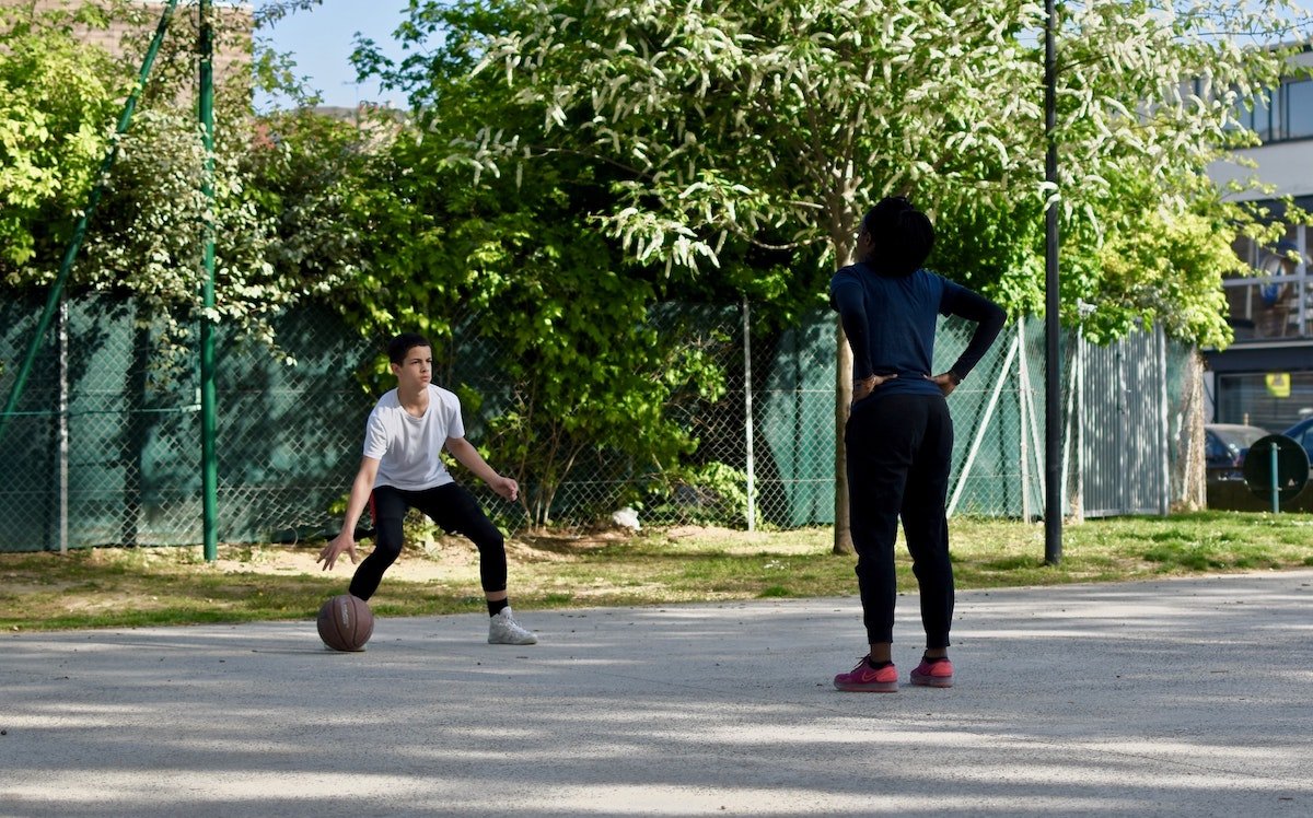 Kids playing basketball in street