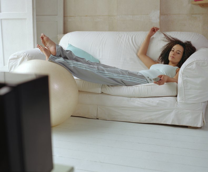 Woman lounging at home watching TV